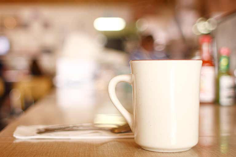 A coffee cup on the counter of a diner