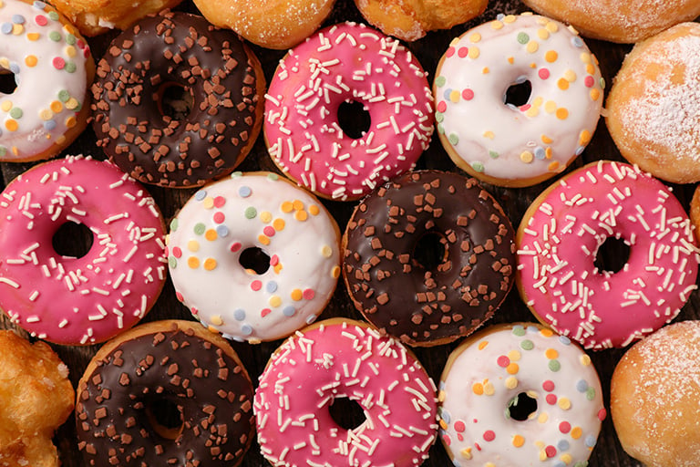 Donut assortment with different colored icing and sprinkles