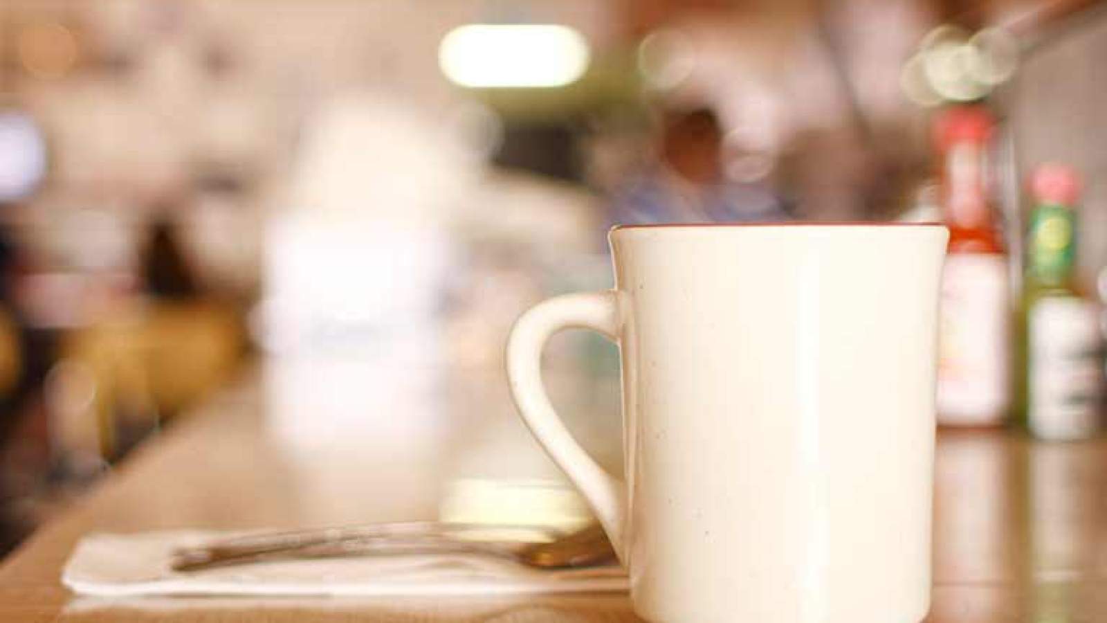 A coffee cup on the counter of a diner