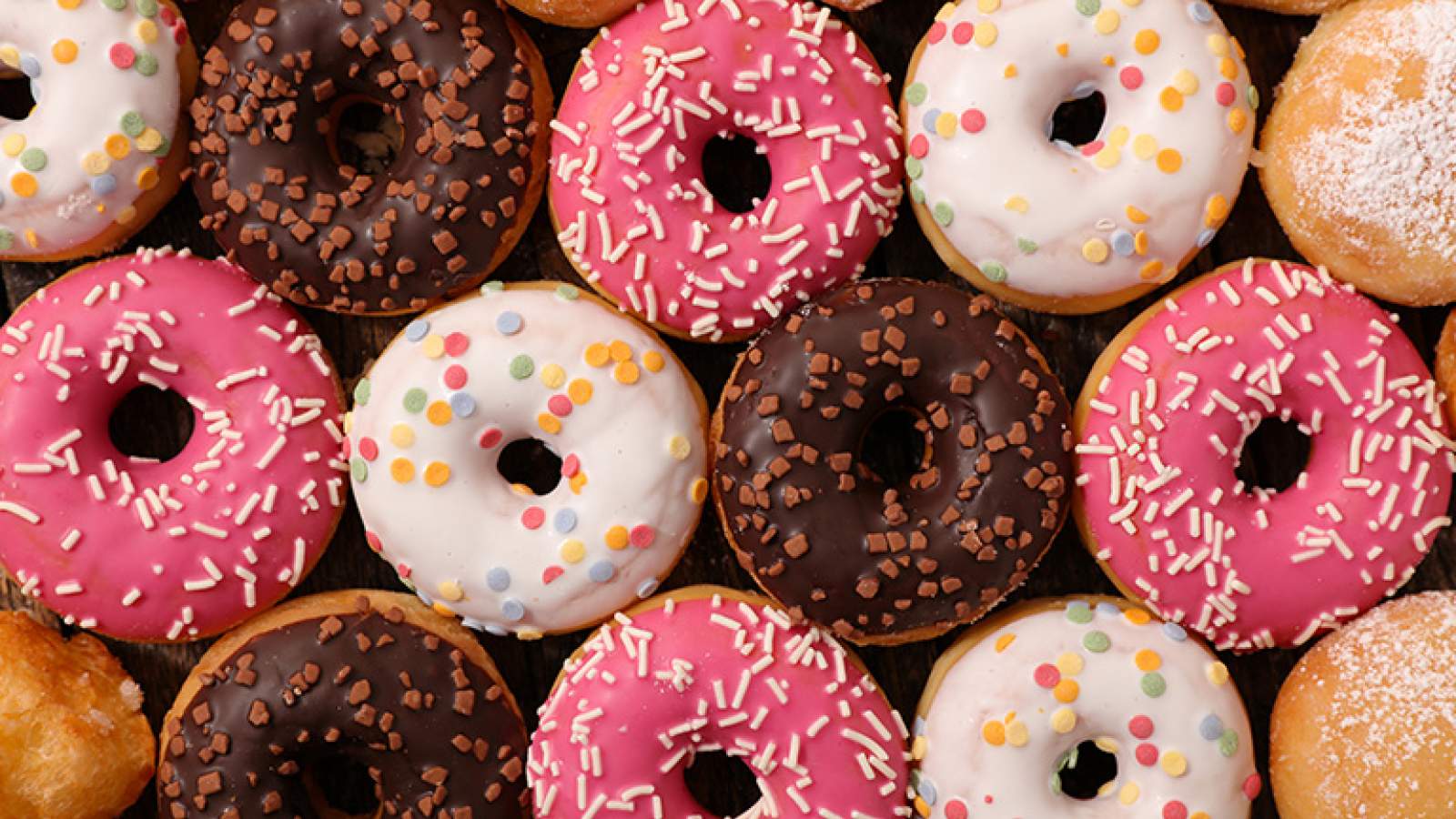 Donut assortment with different colored icing and sprinkles
